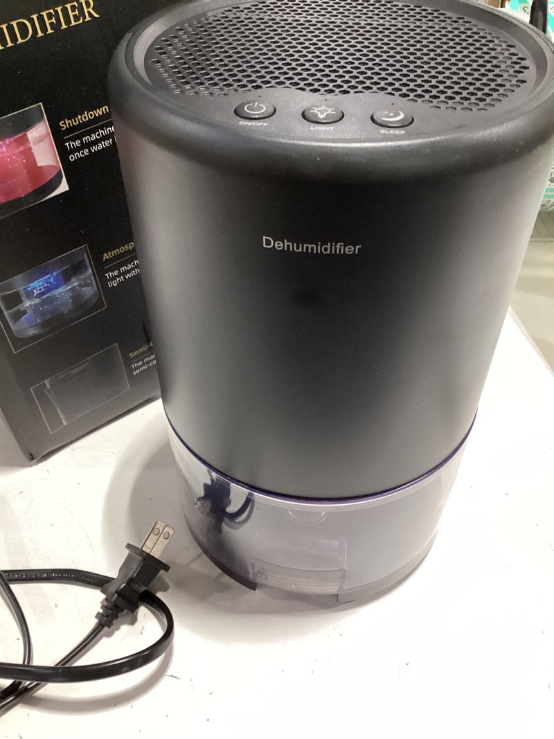 Condition photo showing As Is for dehumidifier, 35 oz small dehumidifiers for home, bathroom, bedroom, closet, ultra-quiet with sleep mode, 7 color lights & auto shut off, compact & portable for rv, rooms, basement, energy saving black