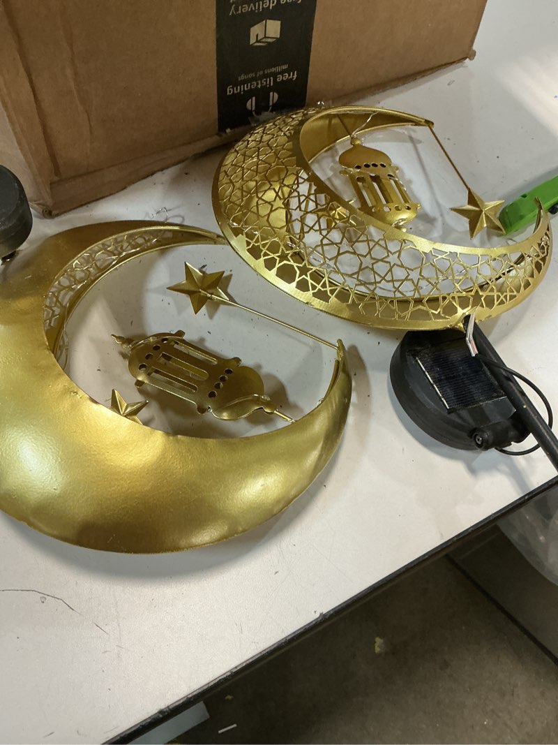 Condition photo showing As Is for lewondr 2pcs ramadan solar lights, ramadan decorations outdoor, metal yard signs led eid decorations mubarak star moon lantern, waterproof solar garden stakes lights for walkway lawn patio