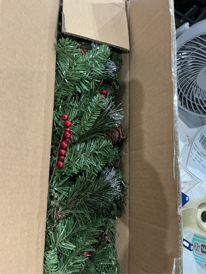 Condition photo showing New/Like New for national tree company 9 ft pre-lit crestwood spruce artificial christmas garland, christmas decoration with glitter, pinecones, red berries, 50 clear lights, 180 tips, green plug in tree