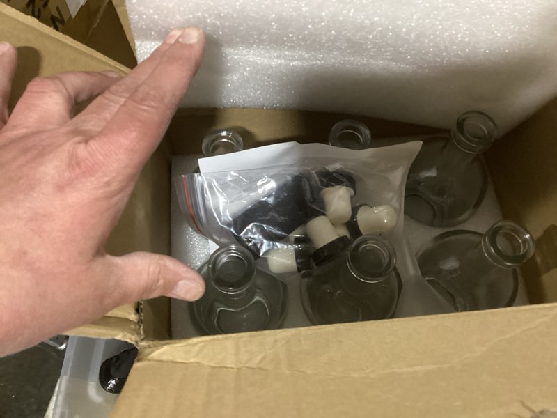 Condition photo showing As Is for 12 oz clear glass bottles with cork, 6 pack 375 ml liquor bottles with t-shaped stopper caps and pvc shrink capsules, empty heavy base vodka bottles for whiskey, wine