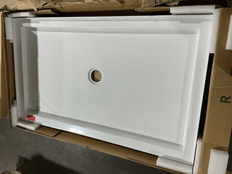Condition photo showing As Is for dreamline slimline 32 in. d x 54 in. w x 2 3/4 in. h center drain single threshold shower base in white, dlt-1132540 white 32 inch d x 54 inch w center drain