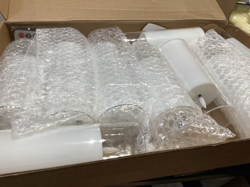 Condition photo showing As Is for kakoya flickering flameless candles battery operated with remote and 2/4/6/8 h timer acrylic led pillar candles pack of 9 (appr d2.3"xh5.5"6.5"7.5")with realistic 3d wick candles for home decor(white) white-1