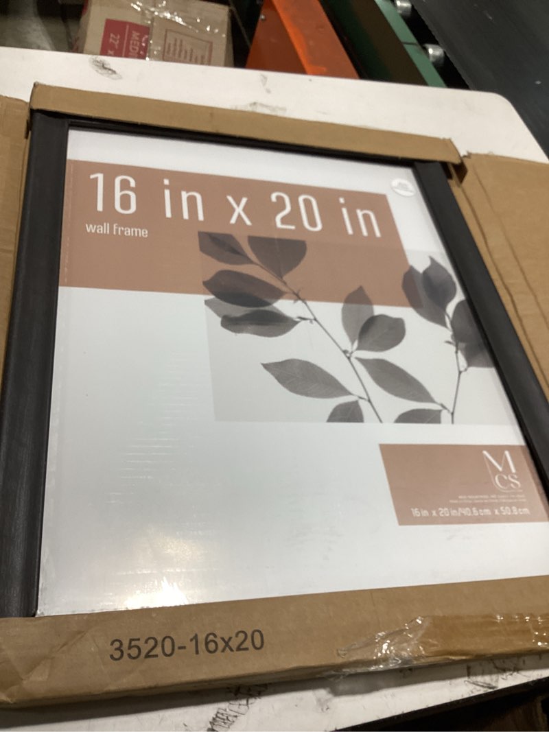 Condition photo showing Good Condition for mcs studio gallery classic 16x20 poster frame black woodgrain engineered wood, vertical & horizontal wall hanging large picture frame for photos, posters & art prints (1-pack) 16x20 black woodgrain
