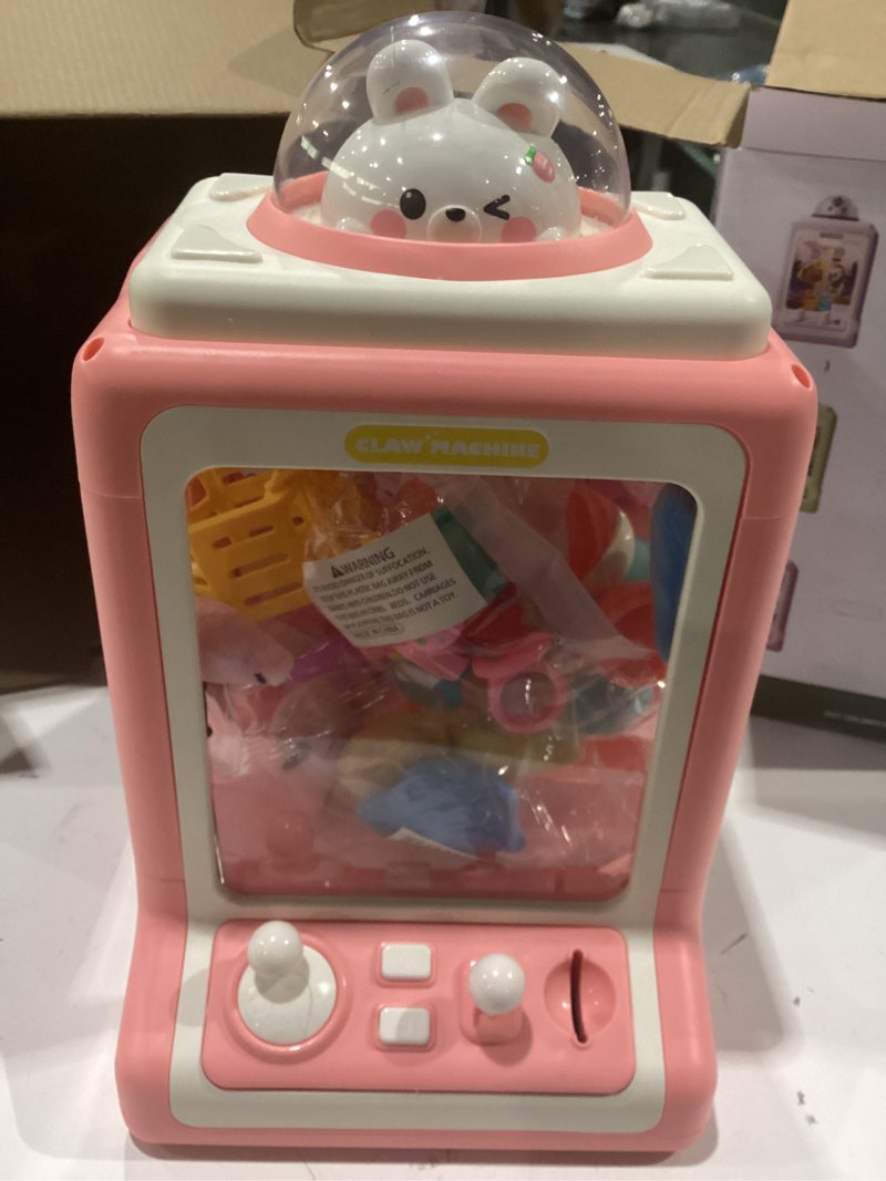 Condition photo showing Good Condition for claw machine for kids, mini vending with game coins & music, prize dispenser toys for girls and boys, electronic claw game for party birthdays, includes 30 mini toys (dinosaur)