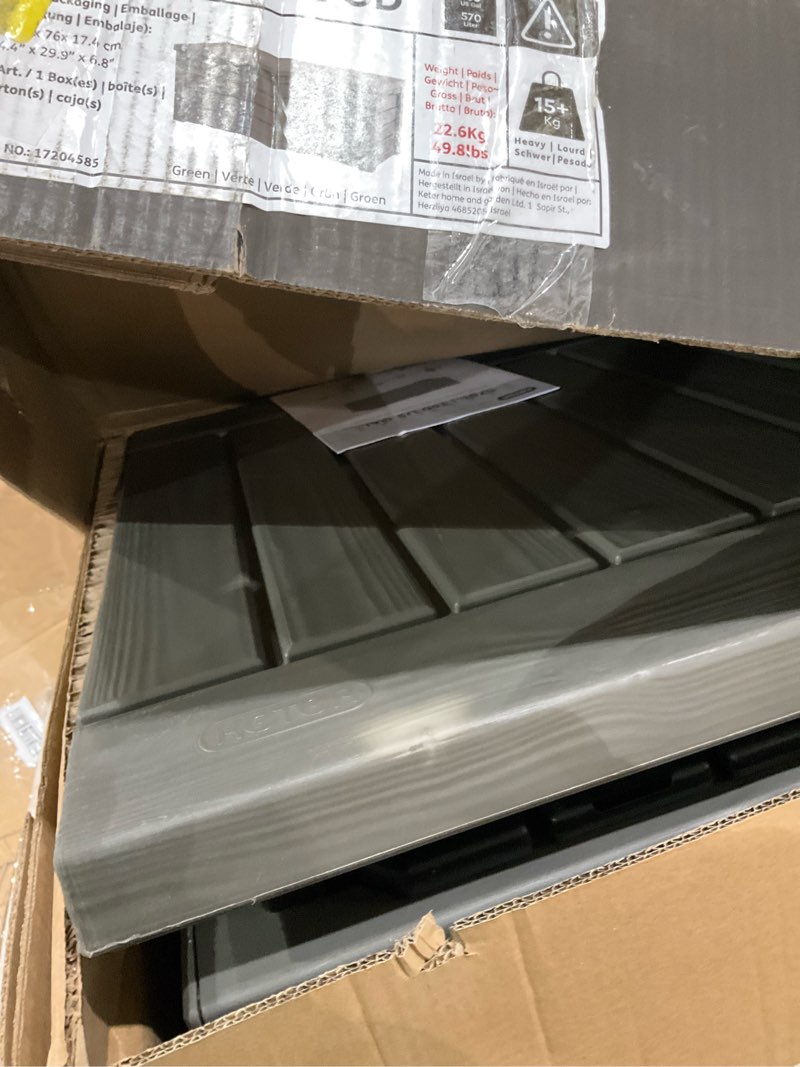 Condition photo showing As Is for keter westwood 150 gallon resin large outdoor storage box for patio furniture, outdoor cushions, garden tools and pool floats, taupe mossy brown