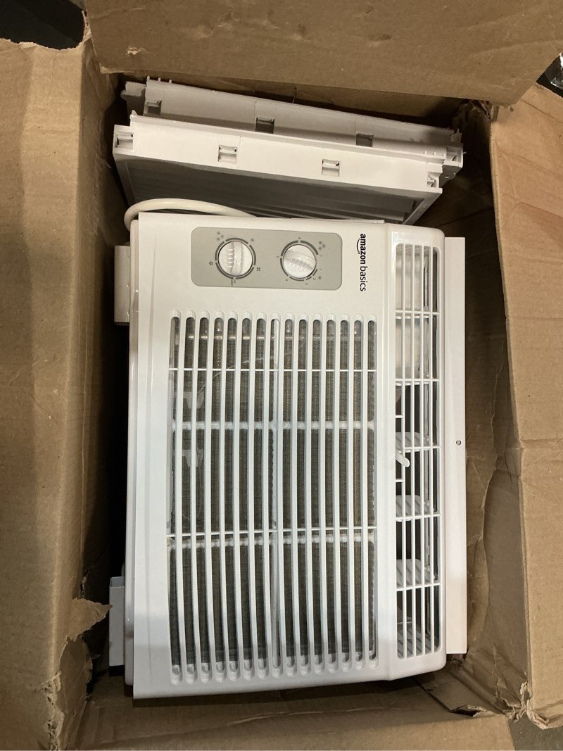 Condition photo showing As Is for amazon basics 6000-btu window air conditioner with quiet operation, up to 250 sqf, cool and fan functions, washable filter, adjustable window kit, digital temperature display, remote control, white