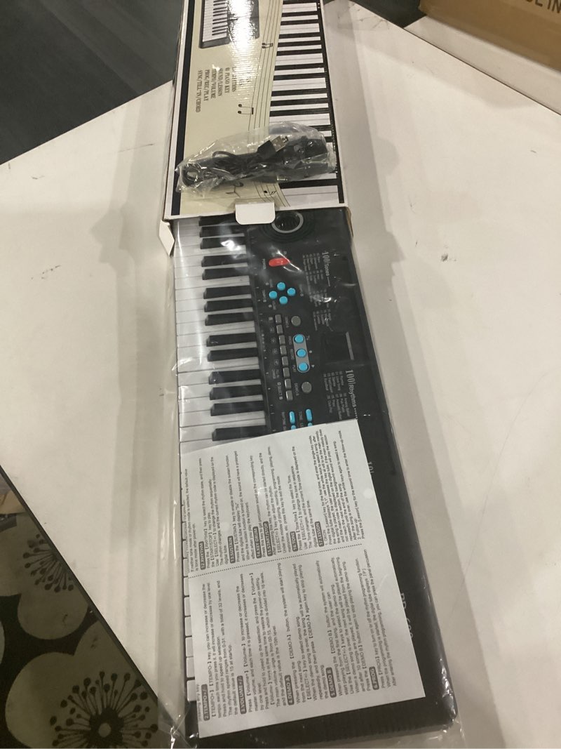 Condition photo showing New/Like New for not tested**** 61 key keyboard piano, portable electronic digital piano, built in dual speakers, external microphone, power plug, rich teaching content, multi-functional electronic piano suitable for beginners