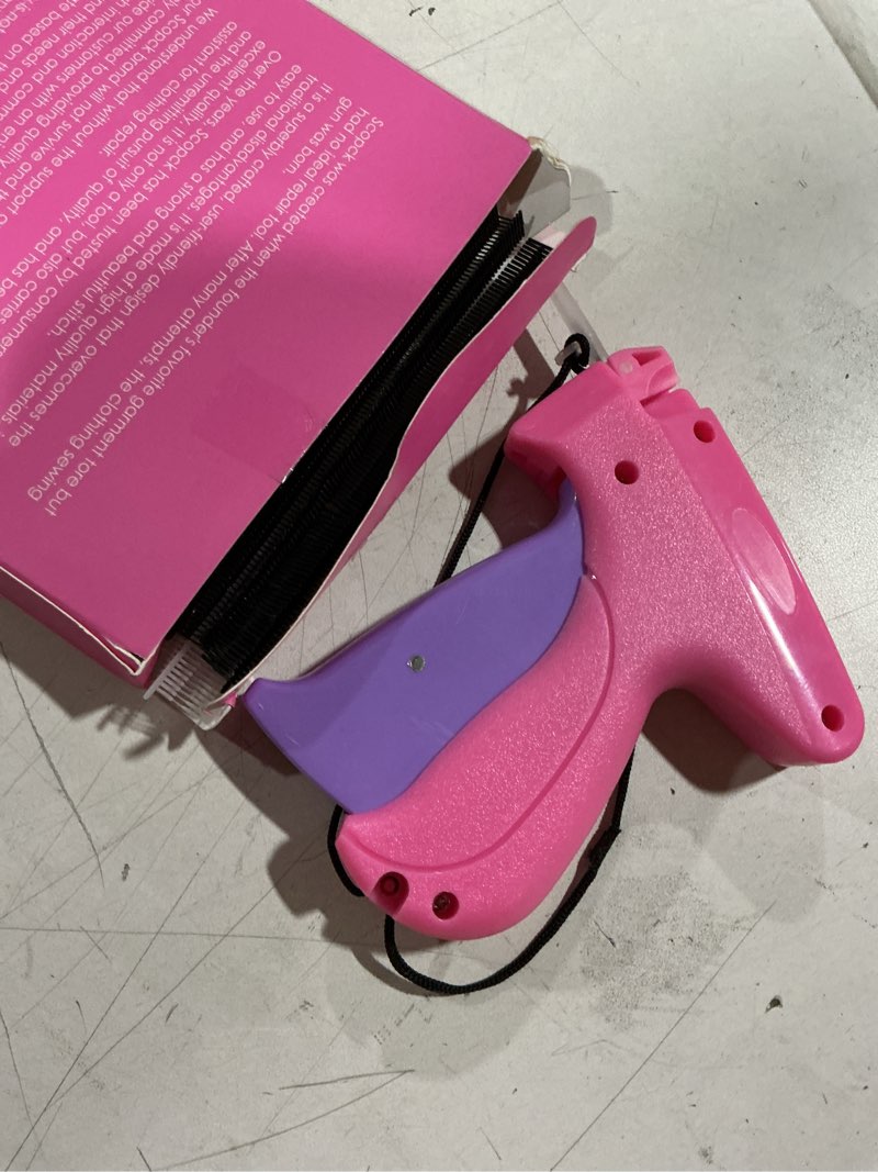 Condition photo showing As Is for stitch gun for clothes - handheld stitch gun quick clothing fixer - tagging gun - includes 6 needle, 1000 black fasteners & 1000 white fasteners pink-purple