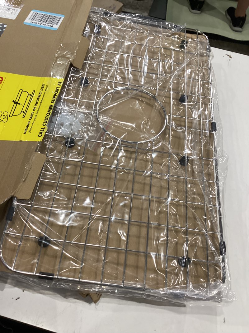 Condition photo showing New/Like New for serene valley sink bottom grid 24-1/8" x 12-5/8", centered drain with corner radius 1-1/2", sink protector nlw2412c