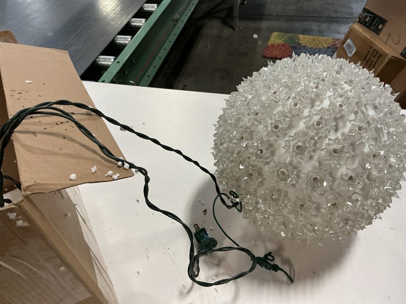 Condition photo showing As Is for Novelty Lights LED 6in 50 Light Starlight Sphere, Pure White, Ornament Ball Light, 5ft Hanging Cord with S Hook, 12ft Power Cord with Stackable Plug, Commercial Grade 50-Light Pure White