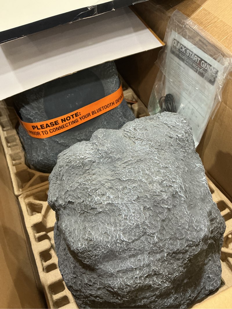 Condition photo showing As Is for victrola the solar rock speakers pair, 14 hours playtime, ipx4 rechargeable solar outdoor bluetooth speakers for garden, patio, built for all seasons, wireless music streaming, charcoal solar charcoal