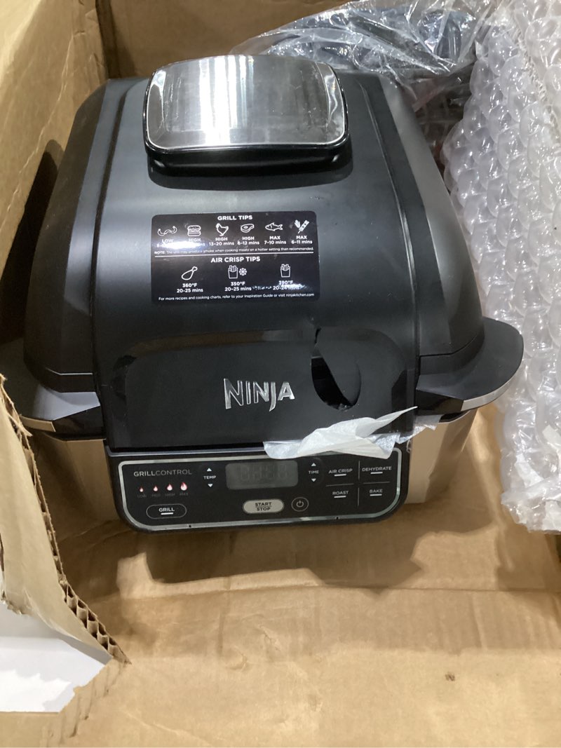 Condition photo showing As Is for ninja | indoor grill | foodi | 5-in-1 (grill, air fry, roast, bake, and dehydrate | fits up to 3lb roast | smoke control system and dishwasher safe parts| black/grey | ag301, not tested, cracked