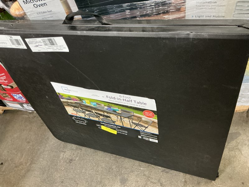 Condition photo showing As Is for 6-foot fold-in-half table black