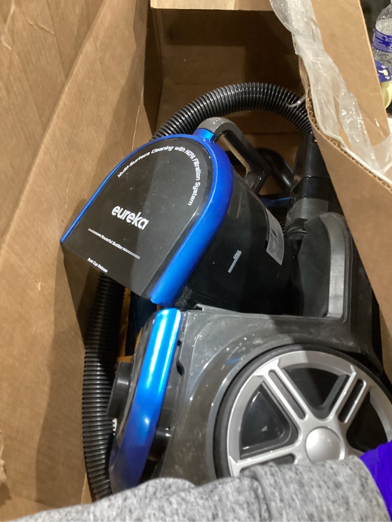Condition photo showing As Is for eureka bagless canister vacuum with washable hepa filter, 16kpa suction for carpets/hard floors, compact design with 3 cleaning tools, 2-motor household vacuum, lightweight and easy maneuverable indigo blue