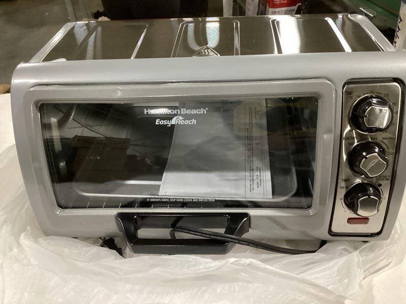 Condition photo showing As Is for Hamilton Beach 6 Slice Countertop Toaster Oven With Easy Reach Roll-Top Door, Bake, Broil & Toast Functions, Auto Shutoff, Silver (31127D)