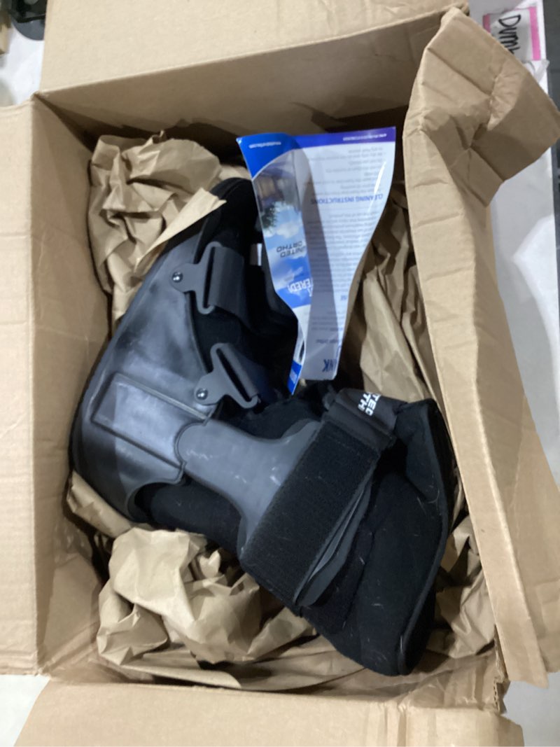 Condition photo showing As Is for *used* united ortho short air cam walker fracture boot, large, black black large boot