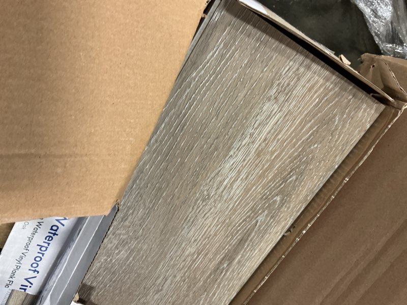 Condition photo showing As Is for 2 pack procore plus dove tail oak 7-in wide x 5-mm thick waterproof interlocking luxury vinyl plank flooring (23.21-sq ft)