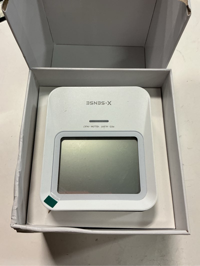Condition photo showing As Is for x-sense radon detector, audible & visual alerts, one-touch reset, stores up to 99 local reports, with temperature & humidity range display, long-term accurate monitoring up to 999 days, model xr0b-sr soft white