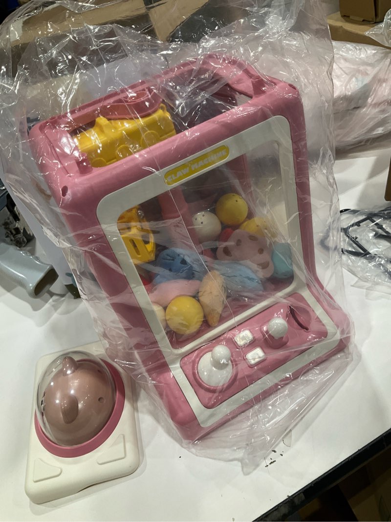 Condition photo showing Good Condition for claw machine for kids, mini vending machine with game coins & music, prize dispenser toys for girls and boys, electronic claw game machine for party birthdays, includes 35 mini toys (doggy pink)