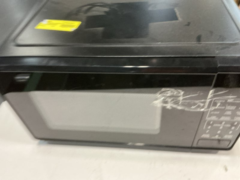 Condition photo showing As Is for mainstays 0.7 cu ft countertop microwave oven, 700 watts