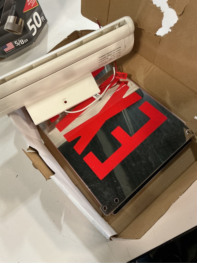 Condition photo showing As Is for basics edge-lit 120-volt integrated led white surface mount exit sign with red letters