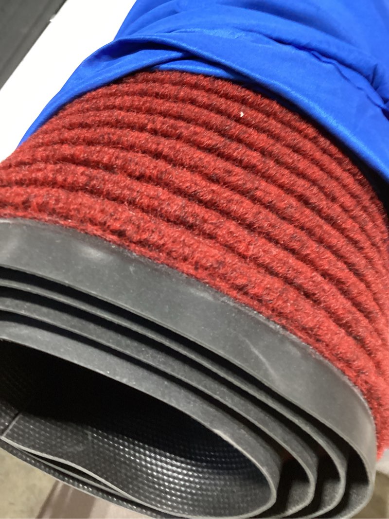 Condition photo showing As Is for large outdoor ribbed red carpet outdoor rug