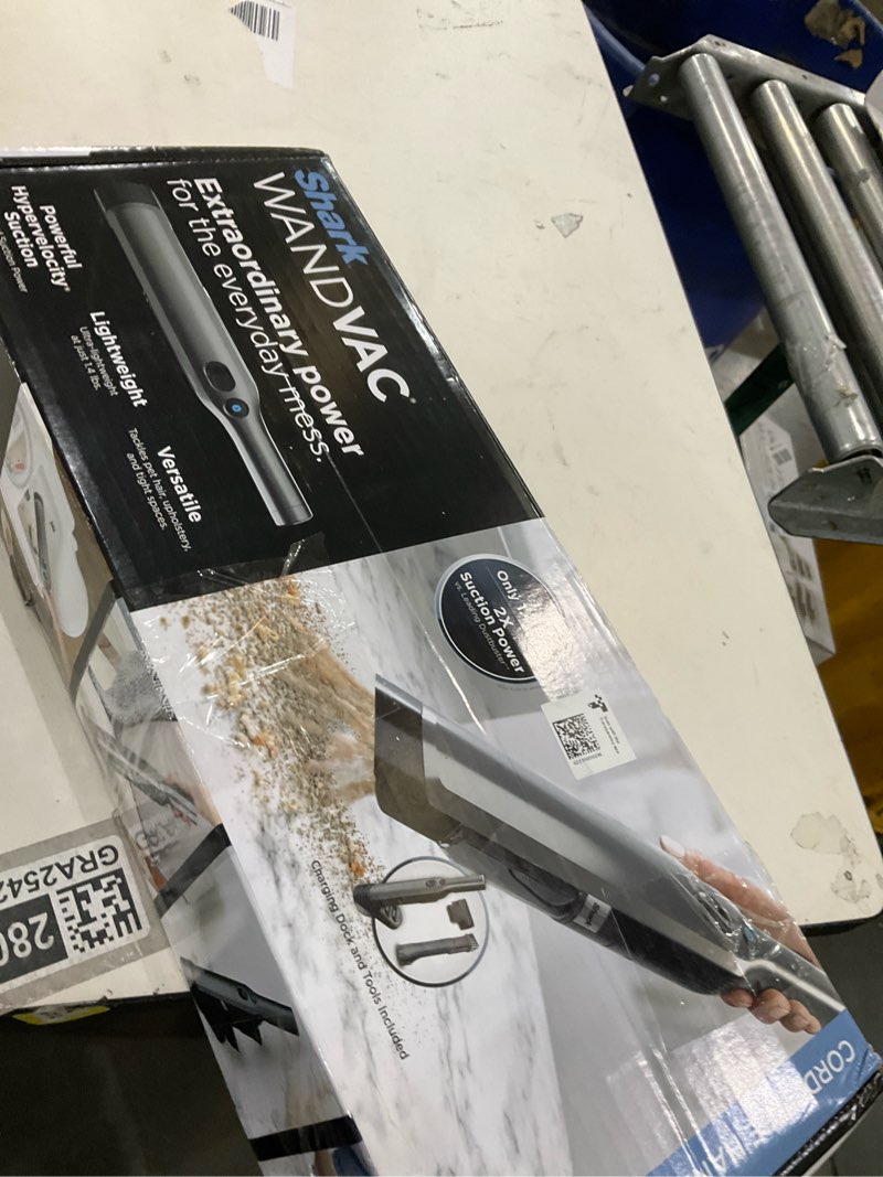 Condition photo showing New/Like New for Shark WV201 WANDVAC Handheld Vacuum, Lightweight at 1.4 Pounds with Powerful Suction, Charging Dock, Single Touch Empty and Detachable Dust Cup,Graphite, Slate