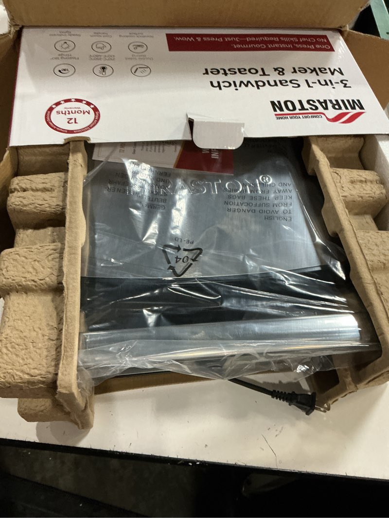 Condition photo showing New/Like New for electric panini press grill and sandwich maker / 8.5" x 11" non-stick coated plates, opens 180 degrees to fit any type or size food, dishwasher safe, sliver