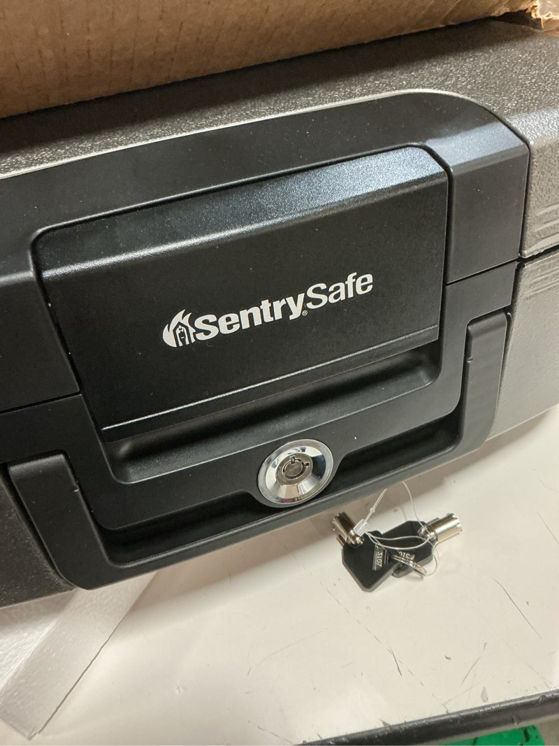 Condition photo showing As Is for sentrysafe dark gray fireproof and waterproof safe with key lock, chest lock box with carrying handle for travel, 0.28 cubic feet, 6.6 x 15.4 x 14.3 inches, cfw20201 1 hr. fireproff, no lid straps