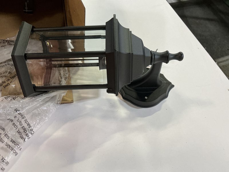 Condition photo showing As Is for project source henfield 1-light 11.81-in h matte black outdoor wall light