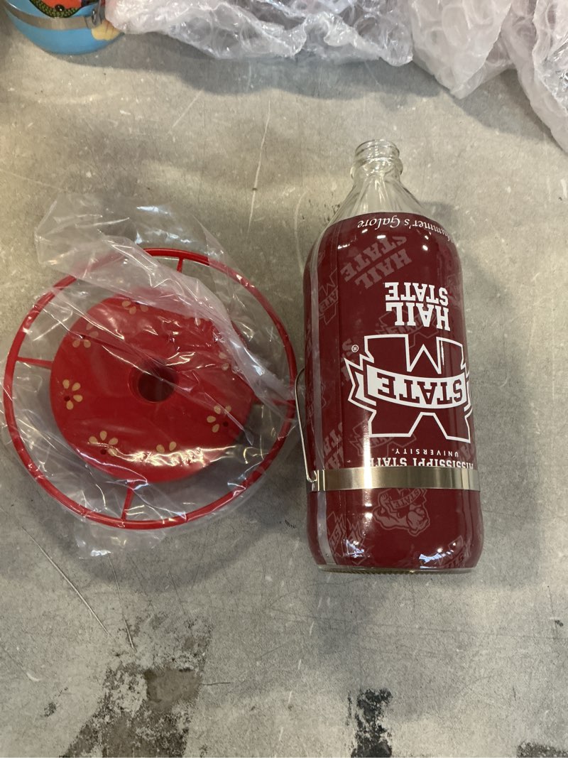 Condition photo showing New/Like New for Hummer's Galore, NCAA College Football Hummingbird Feeder, Glass Hummingbird Feeder with UV Resistant Plastic Wrap for Outdoors Hanging, 32 oz, (Mississippi Bulldogs)