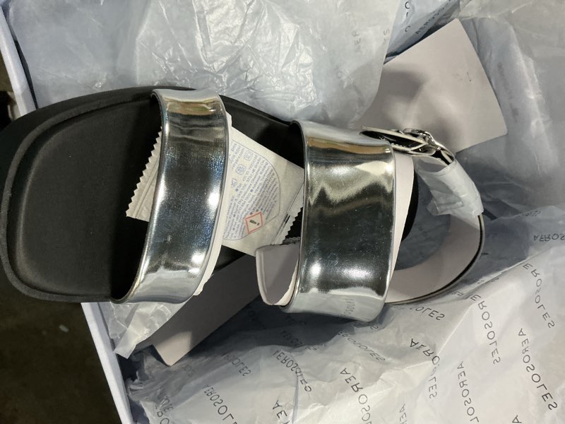 Condition photo showing New/Like New for aerosoles women's dove dual strap heeled sandal, silver mirror metallic pu, 9.5m
