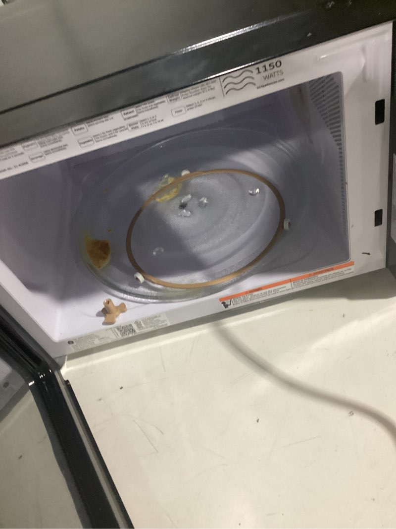 Condition photo showing As Is for countertop microwave oven (stainless steel)