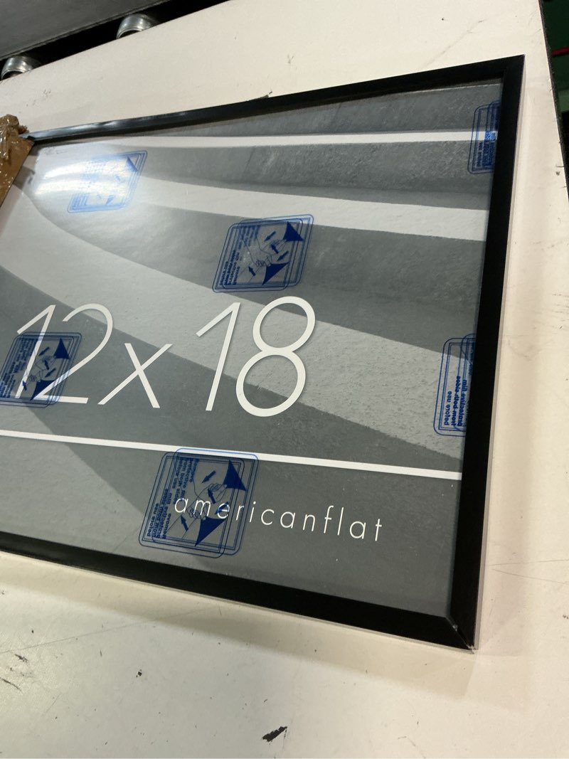 Condition photo showing As Is for americanflat 18x12 picture frame with polished plexiglass - streamline collection - thin border picture frame for wall display - hanging hardware included - black 18x12 black