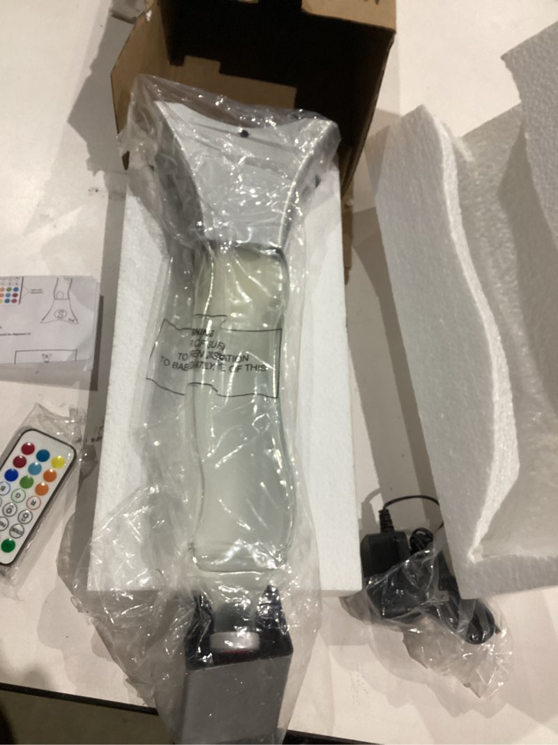 Condition photo showing Good Condition for unique curved liquid motion lamp with led color changing, decorative lamp for bedroom, living room, office, black base with 's' logo and white wax, novelty lighting gift for adults & kids-silver