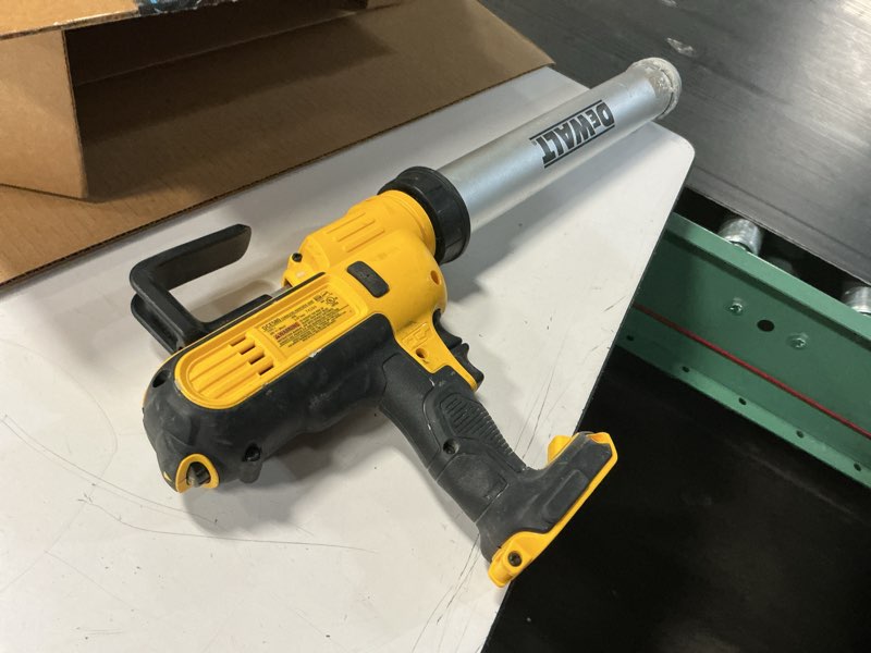 Condition photo showing As Is for dewalt 20v max* cordless caulking gun, sausage pack, 300-600ml, tool only (dce580b)