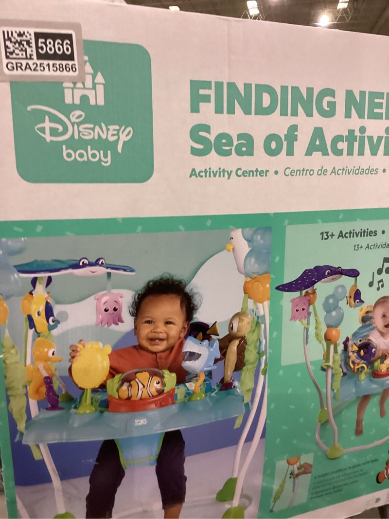 Condition photo showing New/Like New for Bright Starts Disney Baby Finding Nemo Sea of Activities Baby Activity Center Jumper with Interactive Toys, Lights, Songs & Sounds, 6-12 Months (Blue)