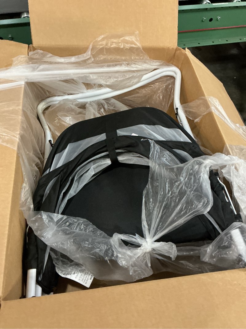 Condition photo showing As Is for dream on me karley bassinet in black, lightweight portable baby bassinet, quick fold and easy to carry, adjustable double canopy, indoor and outdoor bassinet with large storage basket.
