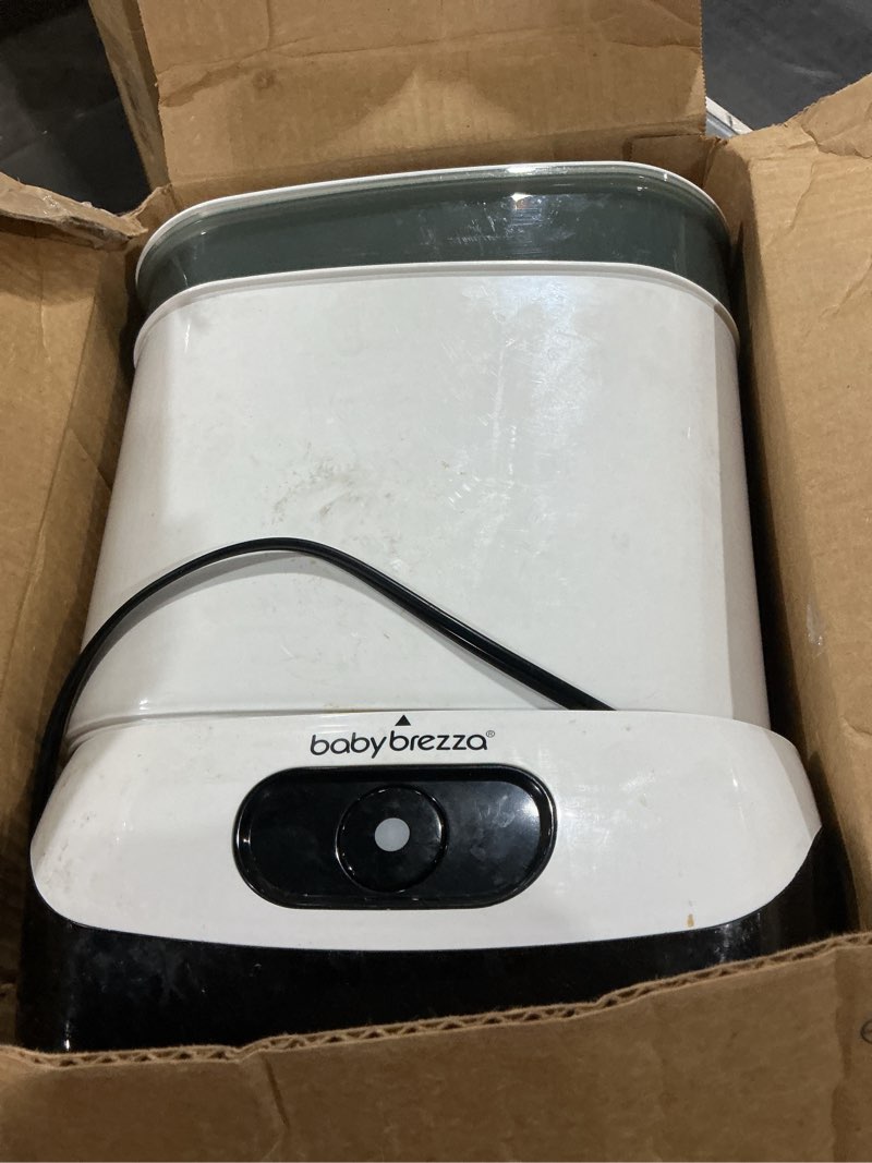 Condition photo showing As Is for (Similar to stock photo) Baby Brezza 4 in 1 Baby Bottle Sterilizer Machine – Largest Capacity Electric Steam Sterilization – Pacifiers, Breast Pump Parts + Universal Sterilizing for All Bottles: Plastic, Glass, Large, Small Sterilizer Without Dryer