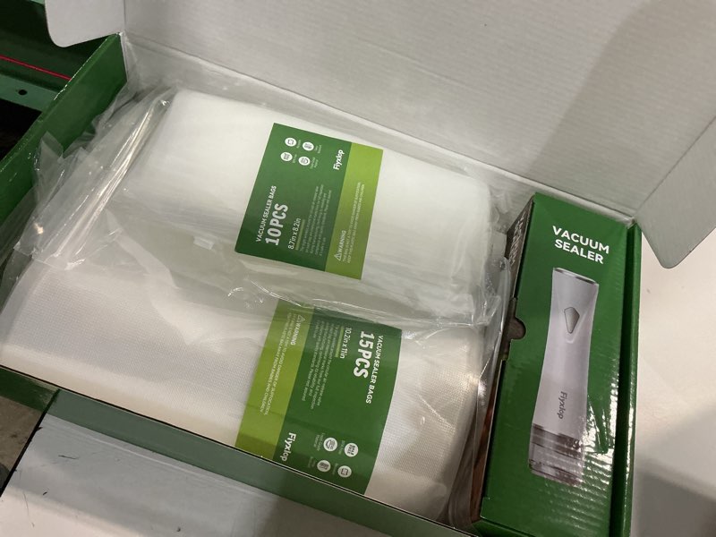 Condition photo showing New/Like New for handheld vacuum sealer, premium vacuum sealer for food + 35 reusable sous vide bags, powerful vacuum food sealer for kitchen, home, bbq, travel