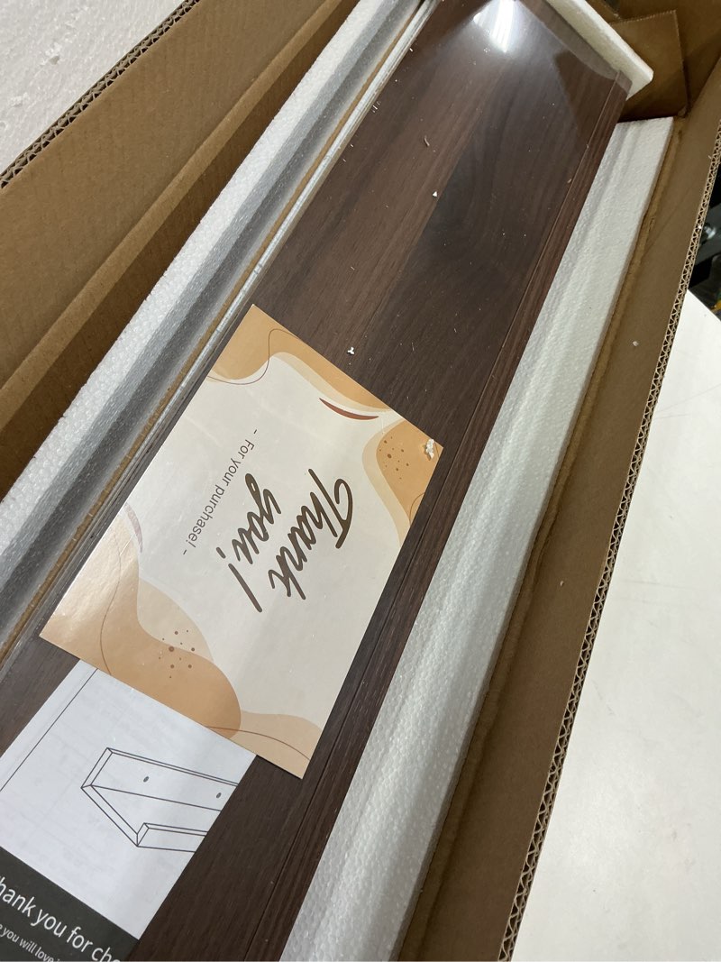 Condition photo showing New/Like New for Dreamland Picture Ledge Shelf for Wall, Floating Shelves Set of 2, 32 Inch Long Floating Shelves with Lip for Living Room, Bedroom, Bathroom, Kitchen, Walnut Walnut 32inch