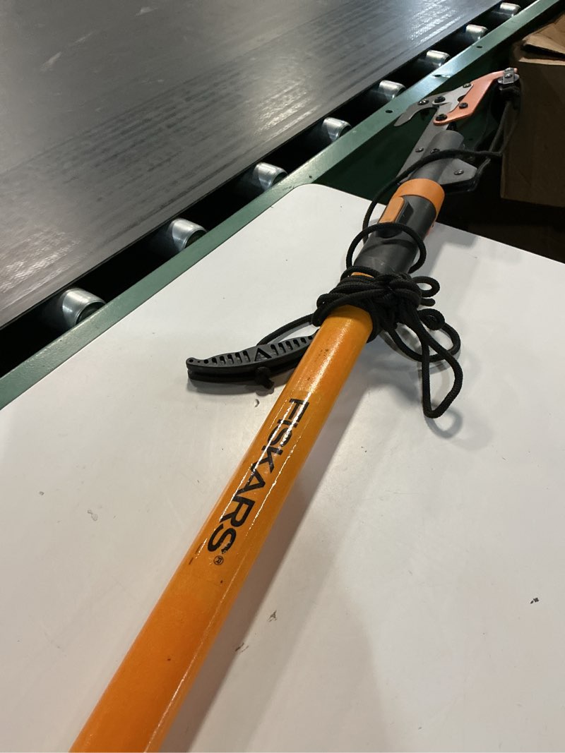 Condition photo showing As Is for fiskars 12' tree pruner & 7" folding saw