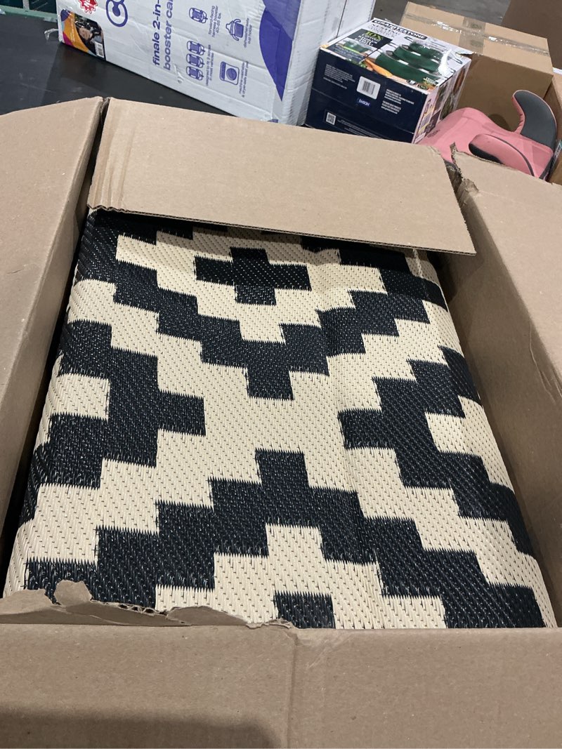 Condition photo showing Good Condition for 5 ft. x 8 ft. waterproof reversible outdoor rug for backyard, black and beige