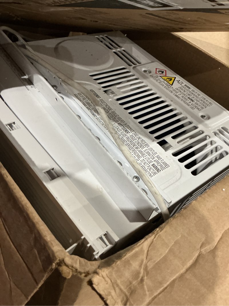 Condition photo showing As Is for frigidaire 5,000 btu window-mounted air conditioner, cools up to 150 sq. ft., quiet operation, effortless temperature control, 2 fan speeds, auto restart, white 5,000 btu mechanical controls