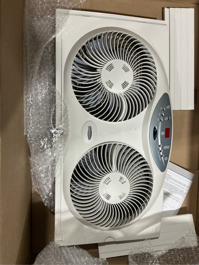 Condition photo showing As Is for bionaire window fan with reversible airflow blades – 3-speed settings, programmable thermostat, led display, remote control, fits 24–36" windows, no assembly required white 2 blades electronic control with lcd screen window fan