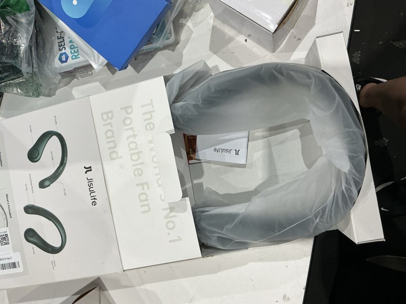 Condition photo showing New/Like New for jisulife portable neck fan, hands free bladeless fan, 5 speeds, 4000 mah battery operated wearable personal fan, twistable, rechargeable, gift for women men-dark green