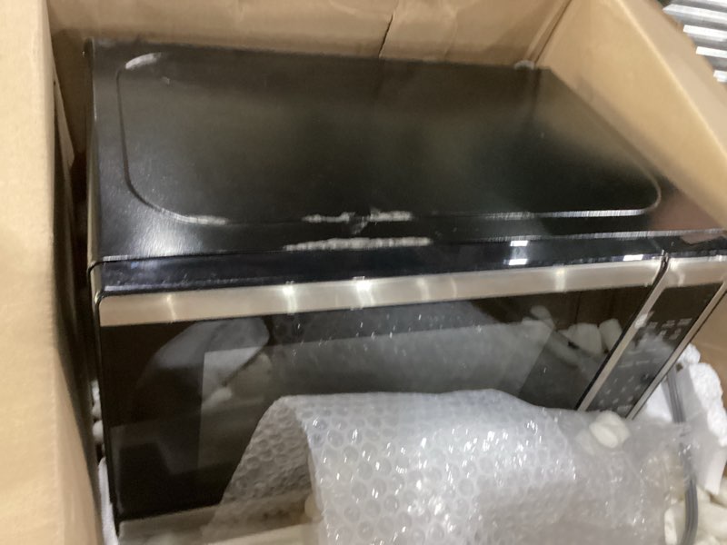 Condition photo showing As Is for BLACK+DECKER EM720CB7 Digital Microwave Oven with Turntable Push-Button Door, Child Safety Lock, 700W, Stainless Steel, 0.7 Cu.ft 0.7 cu. ft.