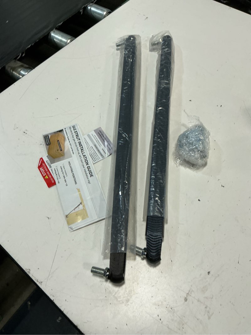 Condition photo showing As Is for arana gas struts 30 inch 55lbs with brackets, 30" gas shocks spring lift support for tv cabinet trap door bench lid floor hatch garbage storage box lid, 2pcs