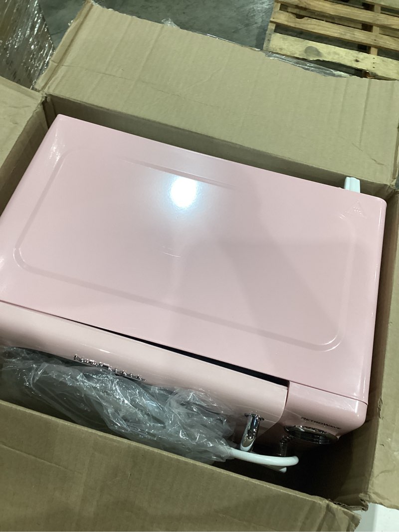 Condition photo showing As Is for nostalgia retro compact countertop microwave oven - 0.7 cu. ft. - 700-watts with led digital display - child lock - easy clean interior - pink retro classic 0.7 cu. ft. pink