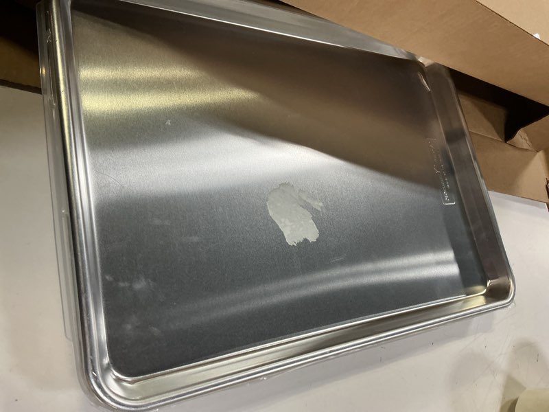 Condition photo showing As Is for Nordic Ware Naturals Half Sheet Set - USA Made Aluminum Commercial Quality Sheet Pan for Baking or Roasting, Encapsulated Galvanized Steel Rim Prevents Warping, 2pk Half + Lid